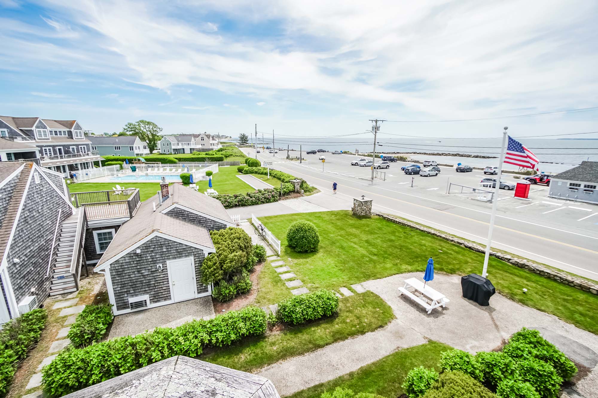 Aerial photo of resort grounds, street and partial ocean view.